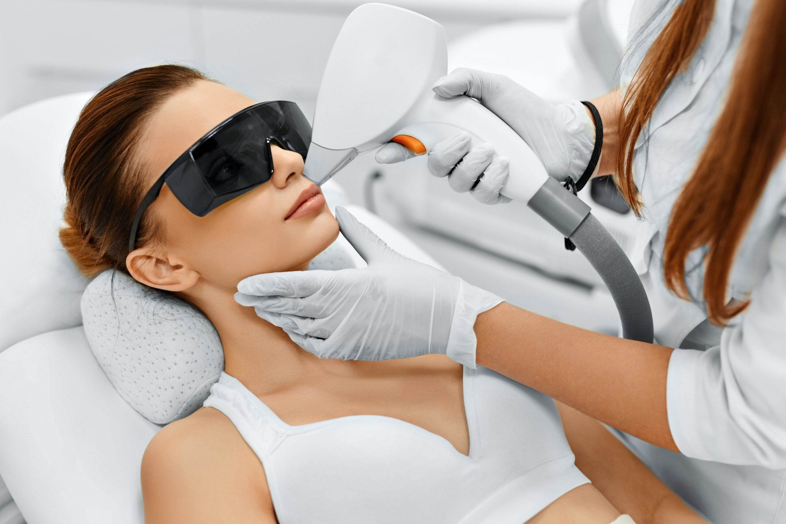 Woman receiving laser treatment on face
